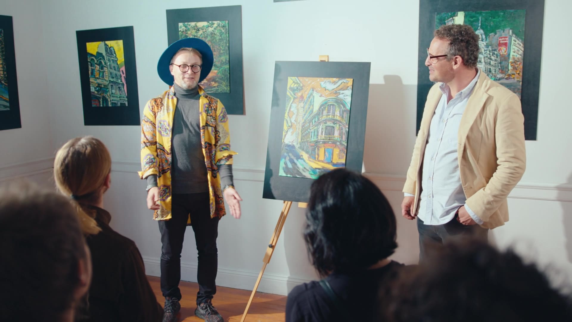 An artist presenting their work to an audience