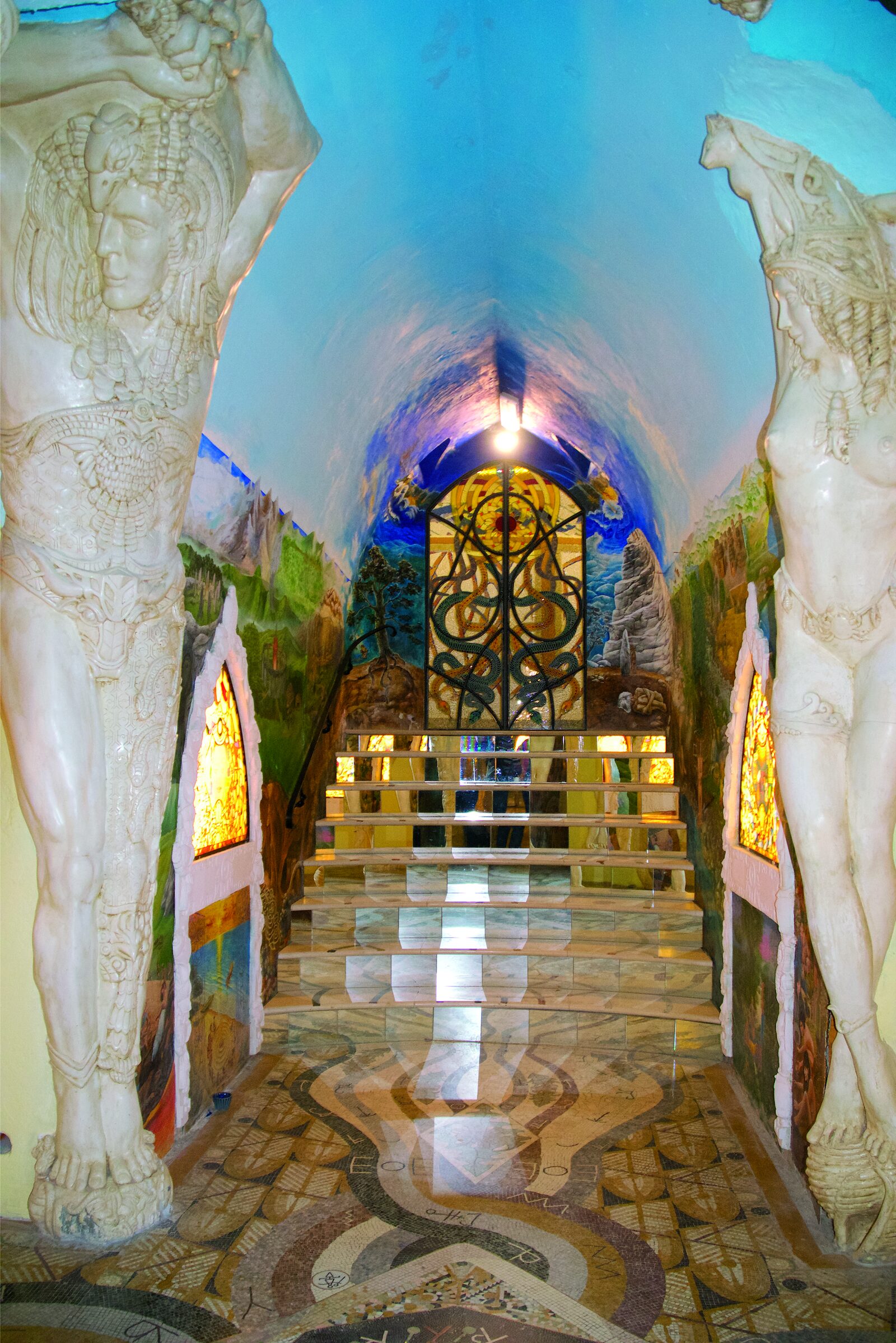 They Built a Cathedral in Secret Beneath an Italian Mountain. Decades Later, It Is Still Growing. | ArtTour International A corridor lined with monumental figures, Temples of Humankind, Damanhur.