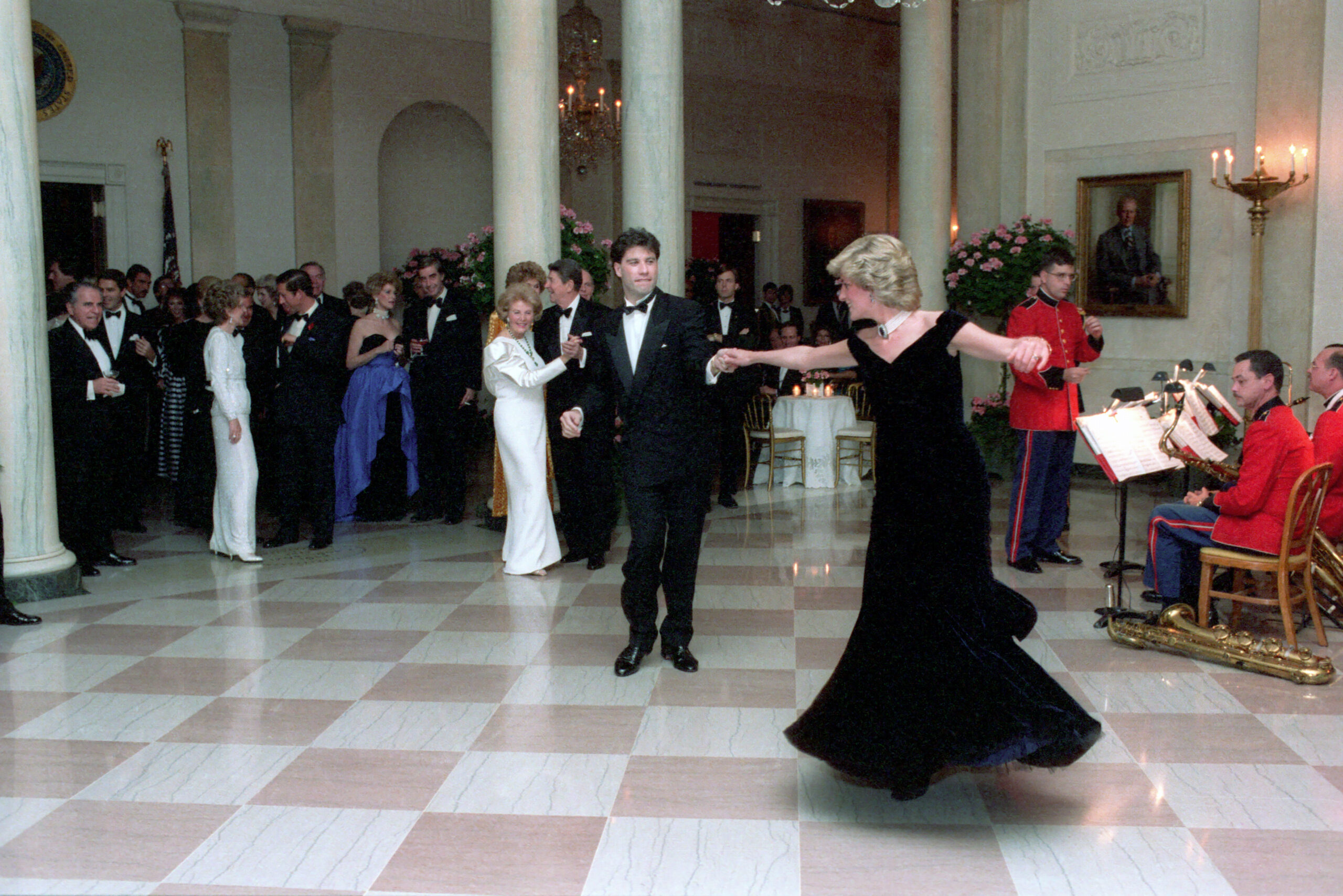 Field: featured image Princess Diana in a midnight-blue velvet gown dancing with John Travolta in the White House Cross Hall in 1985
