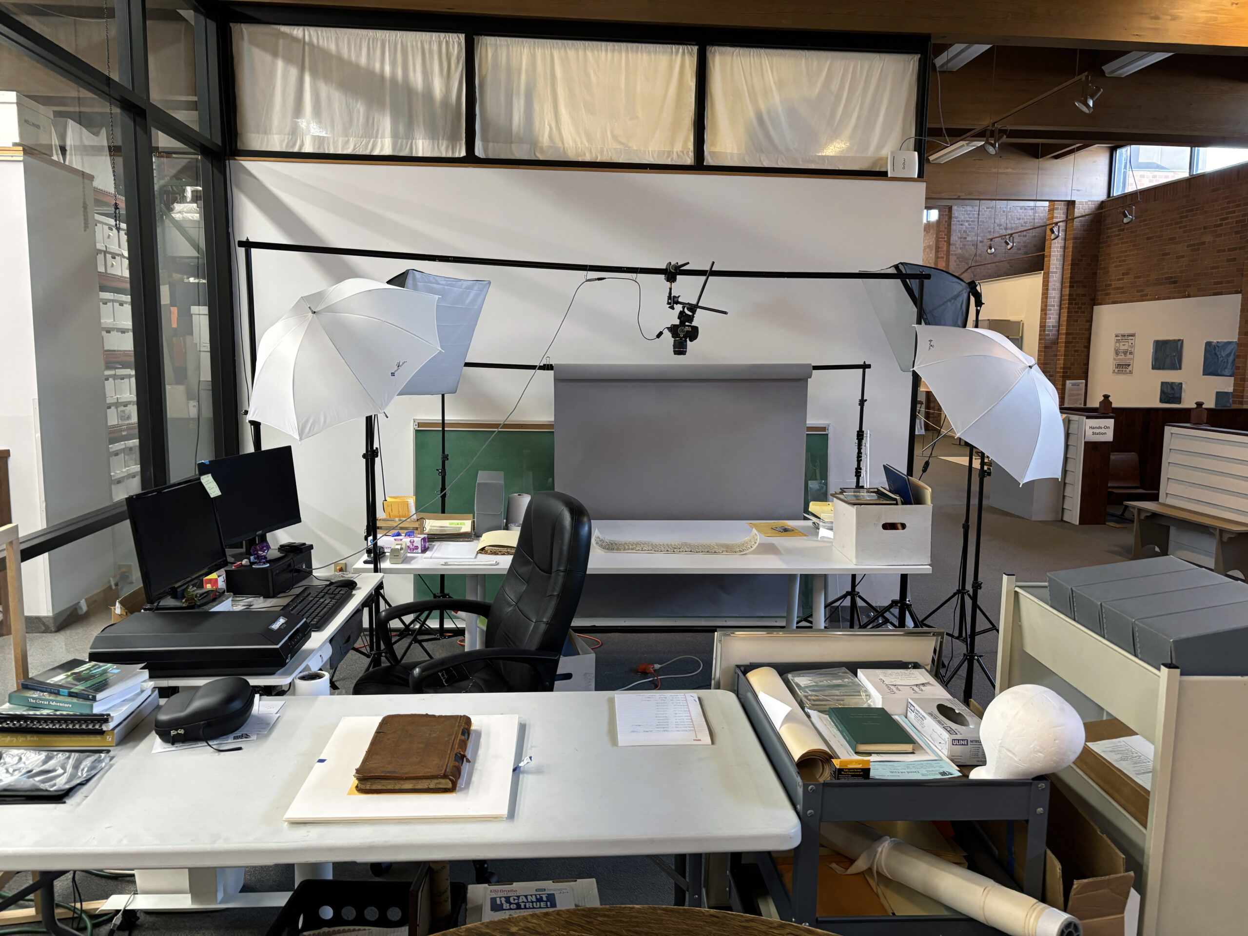 Field: featured image A museum photography setup with lighting and an overhead camera.