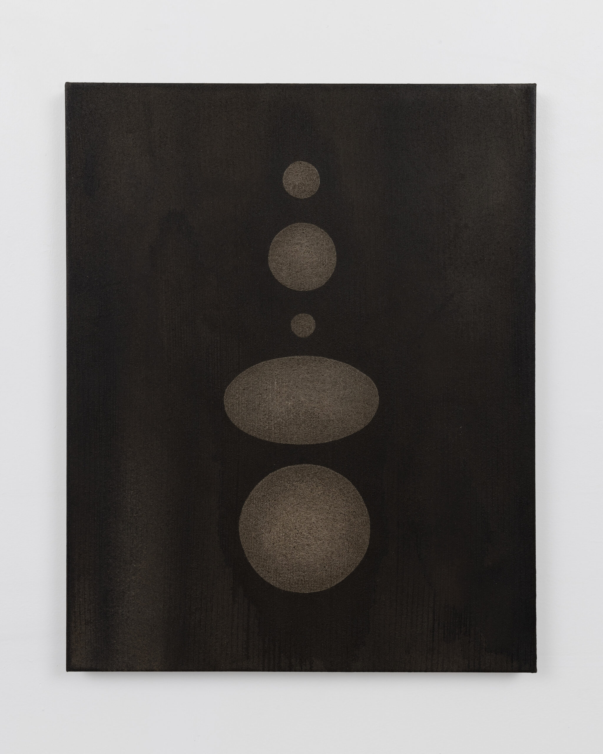 Muted brown circles and an oval arranged along a vertical axis against a dark brown textured background.