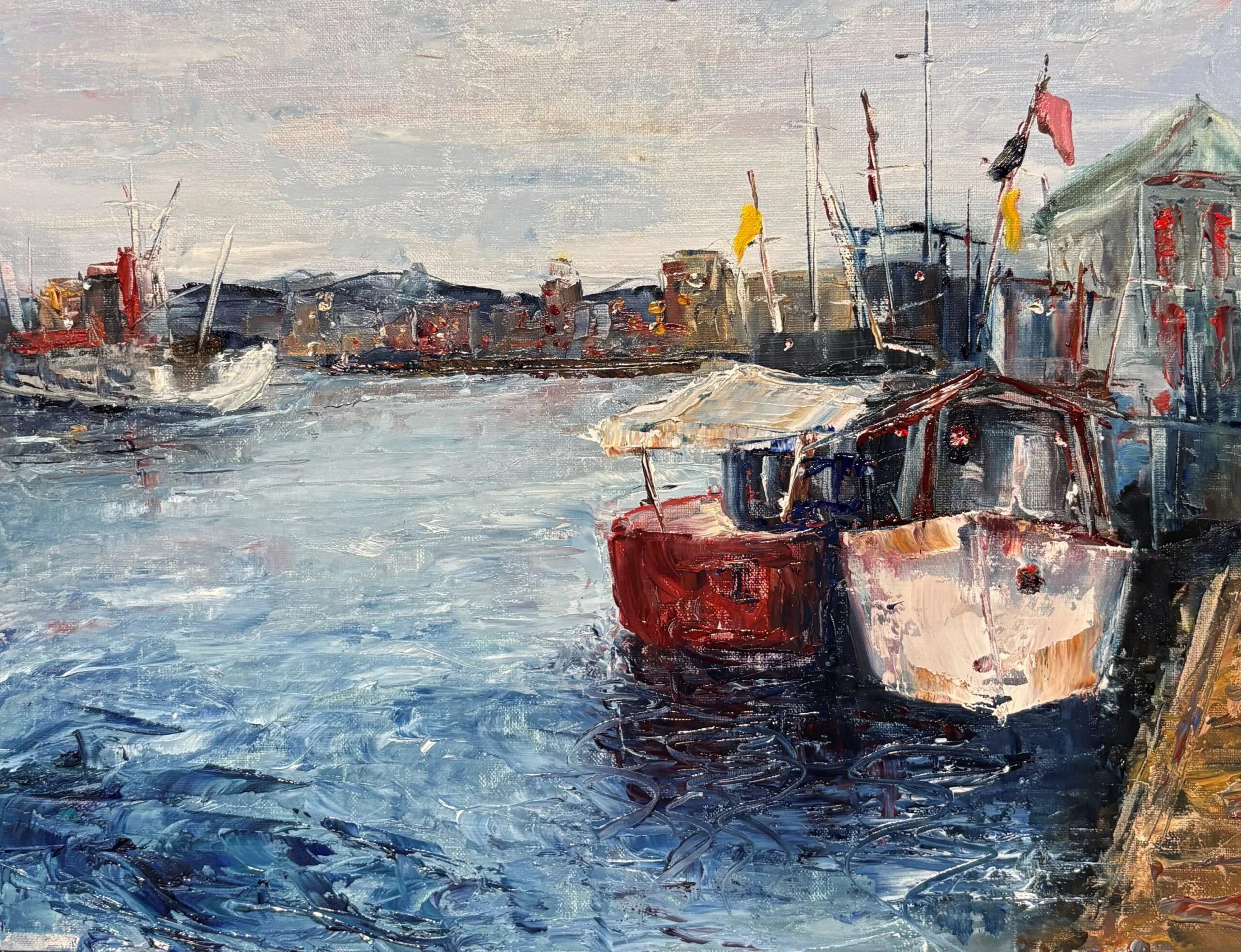 Field: featured image Two red and cream boats docked beside a waterfront, with pale blue water, masts and distant buildings painted in visible textured strokes.