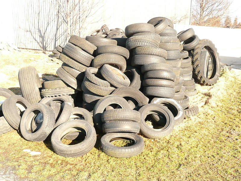 Field: featured image Large stack of used black car and tractor tires