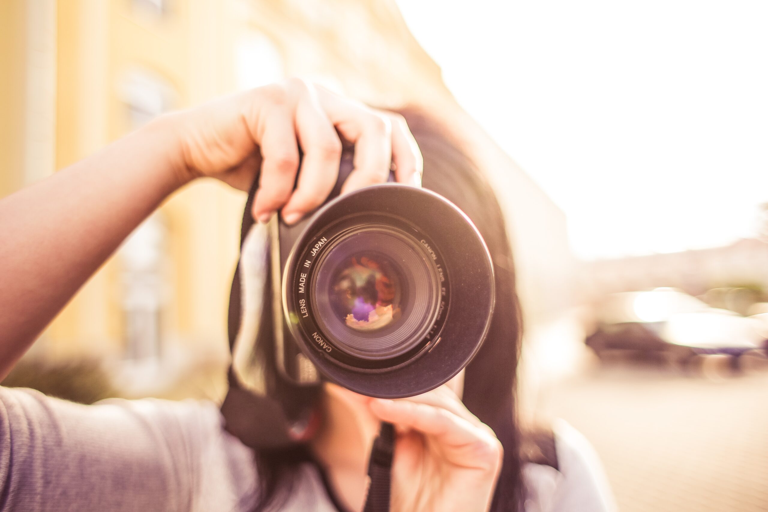 Photographer holding a camera outdoors