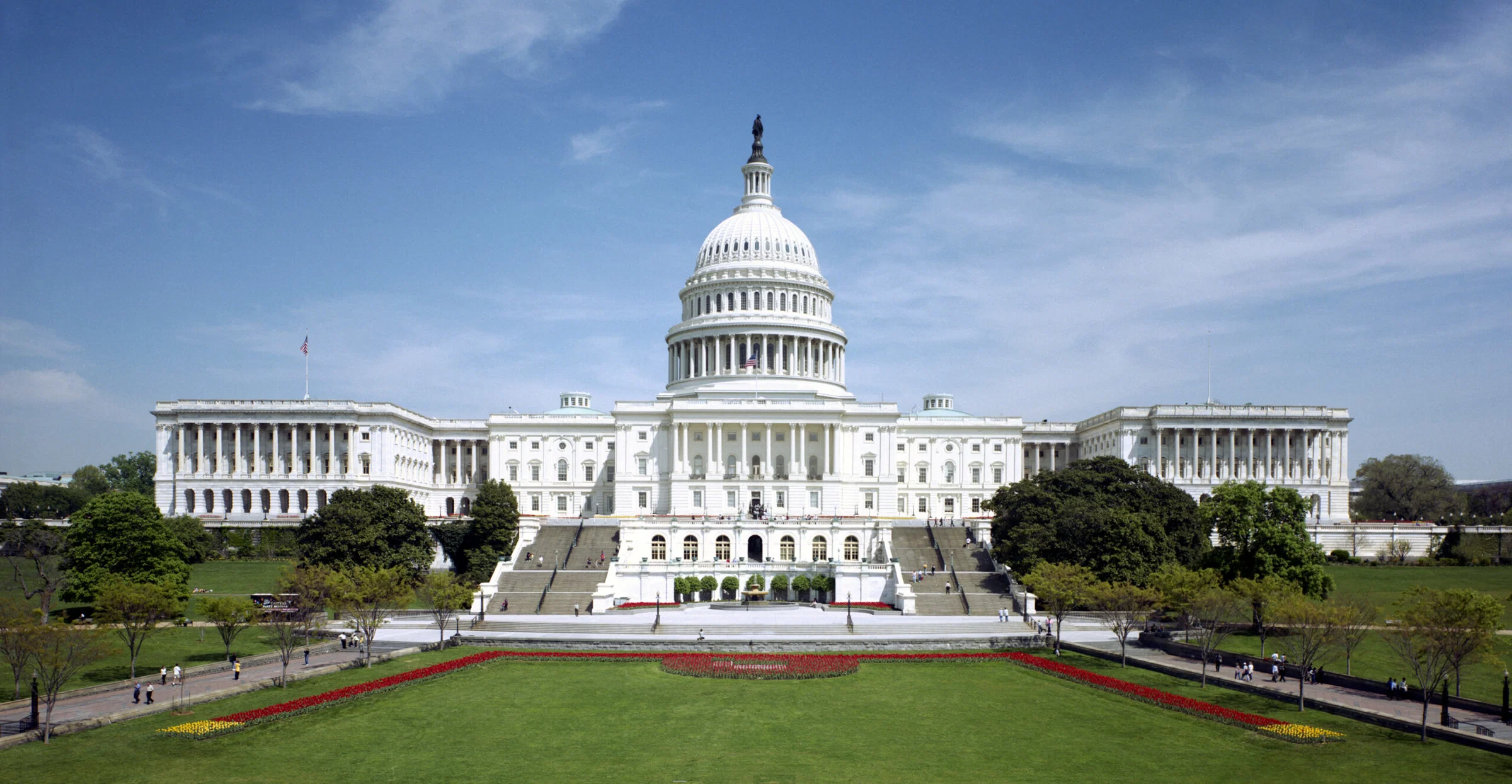 Field: featured image Western front of the United States Capitol beneath a blue sky